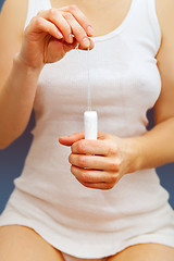 Image showing tampon in hands of woman 