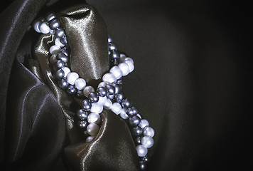 Image showing Natural Pearl Necklaces On The Dark Silk Background