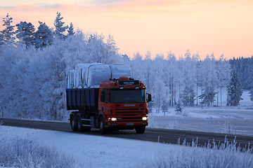 Image showing Scania Tipper Hauls Silage Bales at Winter Sunset