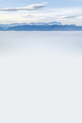 Image showing landscape covered in fog with the alps in the background