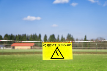 Image showing electric fence at a green meadow