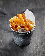 Image showing fried potatoes on wooden table