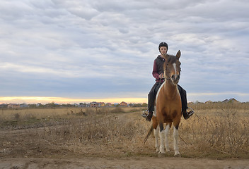 Image showing Happy teenager boy with horse