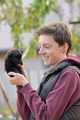 Image showing Teenager with a small puppy