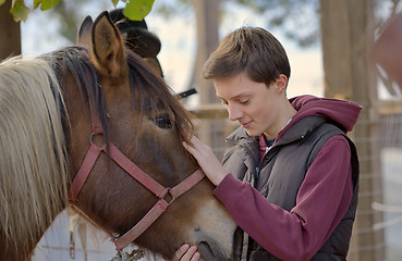 Image showing Happy teenager boy with horse