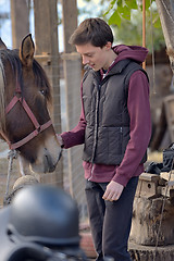 Image showing Happy teenager boy with horse