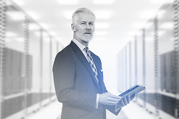 Image showing Senior businessman in server room