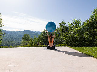 Image showing woman doing exercise with pilates ball