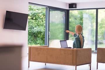 Image showing Young woman using laptop at home