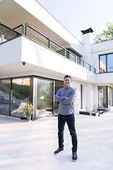 Image showing man in front of his luxury home villa