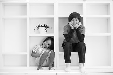 Image showing young boys posing on a shelf