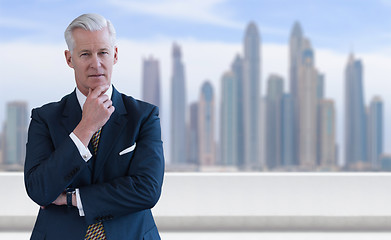 Image showing Senior businessman in front of the big city