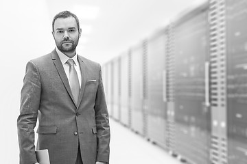 Image showing Young businessman in server room