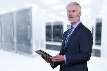 Image showing Senior businessman in server room