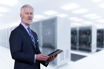 Image showing Senior businessman in server room