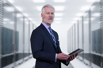 Image showing Senior businessman in server room