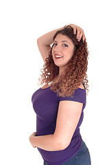 Image showing Curvy woman standing in profile and smiling