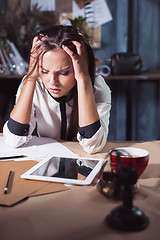 Image showing Young frustrated woman working at office desk in front of laptop