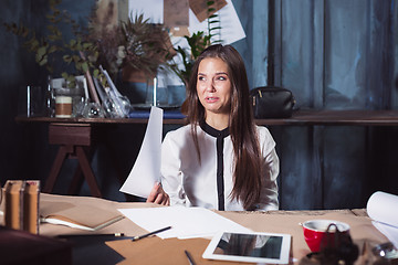 Image showing Young frustrated woman working at office desk in front of laptop