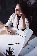 Image showing Architect working on drawing table in office