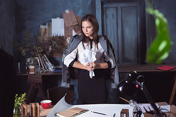 Image showing Young business woman throwing documents at camera.