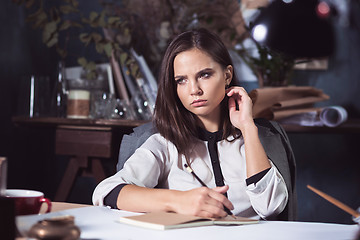 Image showing Architect working on drawing table in office