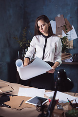 Image showing Architect working on drawing table in office