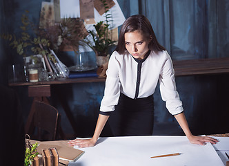 Image showing Architect working on drawing table in office