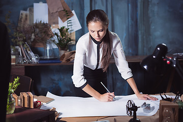 Image showing Architect working on drawing table in office