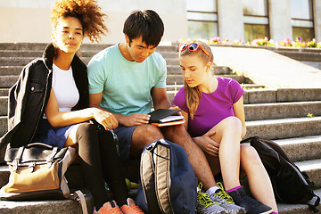 Image showing cute group of teenages at the building of university with books huggings, diversity nations