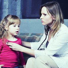 Image showing young doctor with little girl patient feeling bad medical inspection