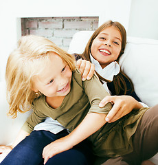 Image showing two cute sisters at home playing