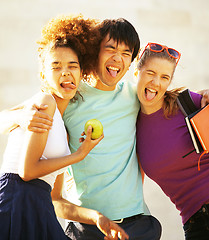 Image showing cute group of teenages at the building of university with books 