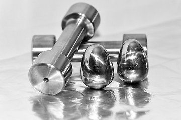 Image showing Metal dumbbells and steel eggs, the concept of sports training a