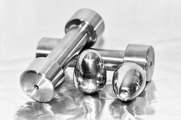 Image showing Metal dumbbells and steel eggs, the concept of sports training and the achievement of muscle strength