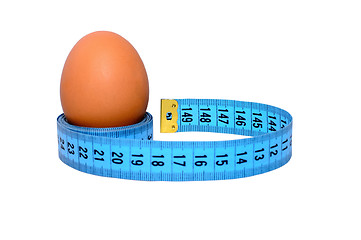 Image showing Egg wrapped in blue measuring tape, slimming concept