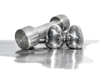 Image showing Metal dumbbells and steel eggs, the concept of sports training and the achievement of muscle strength