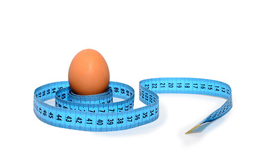 Image showing Egg wrapped in blue measuring tape, slimming concept