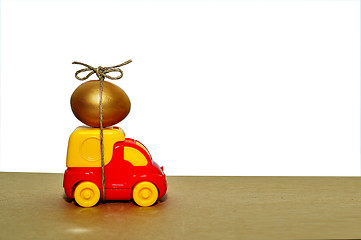 Image showing A toy truck carrying a golden egg, a symbol of the reliability of delivery of postal goods