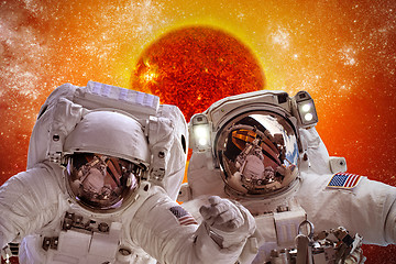 Image showing Spacecraft and astronauts in space on background sun star