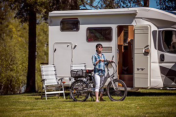 Image showing Woman on electric bike resting at the campsite VR Caravan car Va