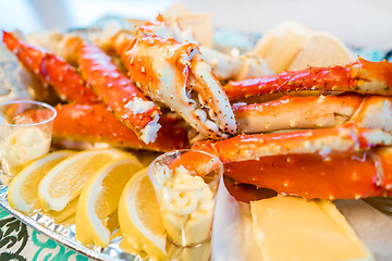 Image showing Red king crab legs with fresh lemon slices