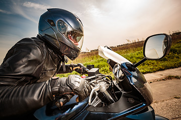 Image showing Biker racing on the road