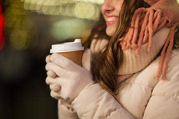 Image showing happy woman with coffee over christmas lights