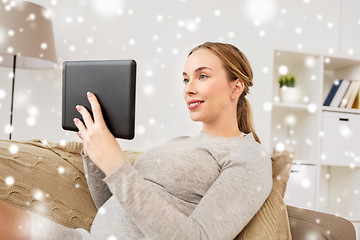 Image showing smiling woman with tablet pc at home