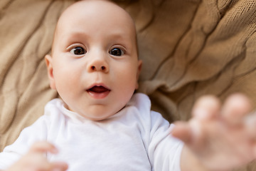 Image showing close up of sweet little baby boy lying on blanket