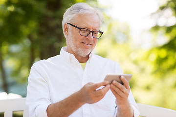 Image showing senior man with smartphone at summer park