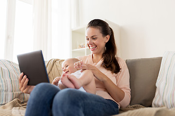 Image showing happy mother and baby boy with tablet pc at home