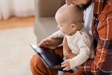 Image showing happy father and baby boy with tablet pc at home