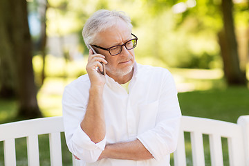 Image showing senior man calling on smartphone at summer park